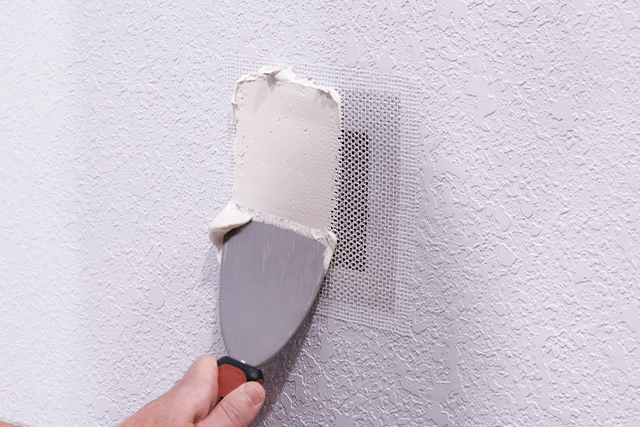 apply drywall compound with flexible putty knife
